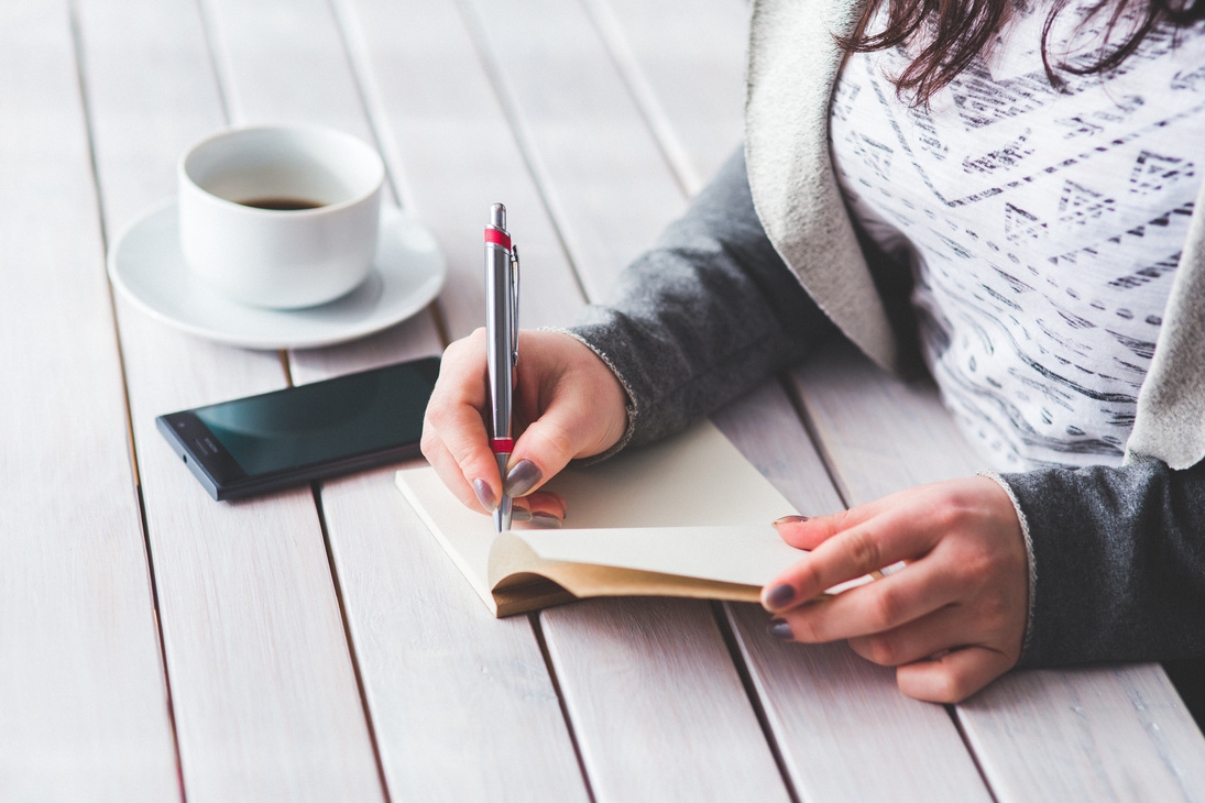 Woman Writing on Her Journal